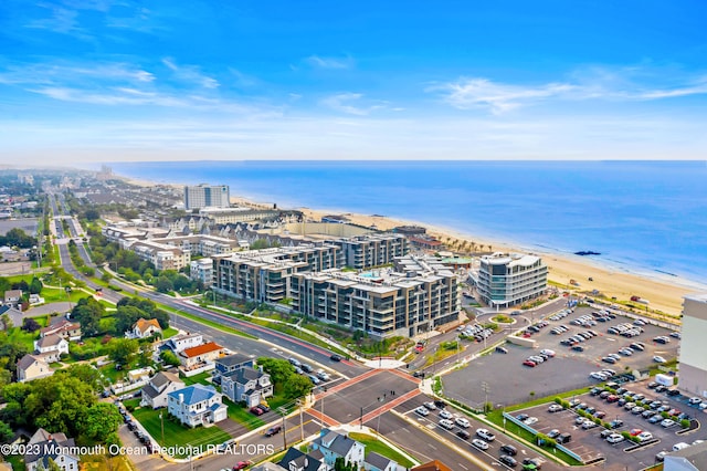 aerial view with a water view and a view of the beach