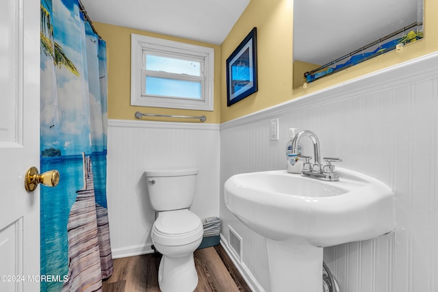 bathroom featuring sink, a shower with curtain, hardwood / wood-style flooring, and toilet