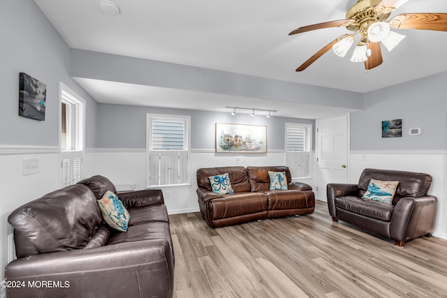 living room featuring track lighting, light wood-type flooring, and ceiling fan