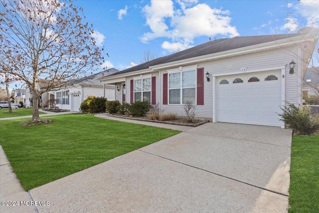 ranch-style home featuring a front lawn and a garage