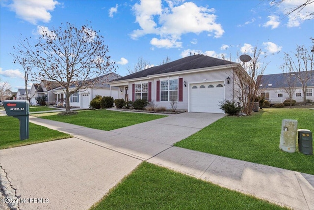 ranch-style home featuring a garage and a front lawn