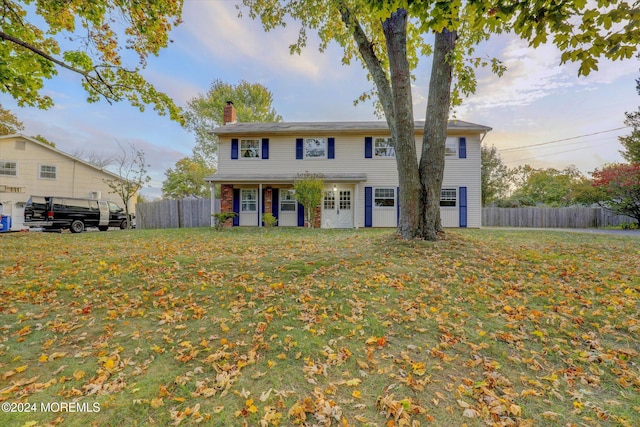 colonial inspired home featuring a lawn