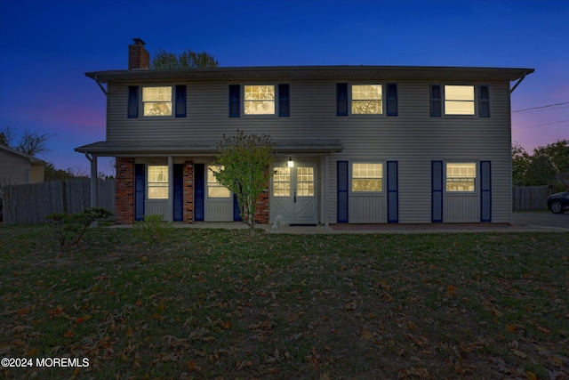 colonial-style house featuring a yard