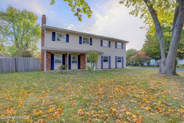 colonial inspired home with a front yard