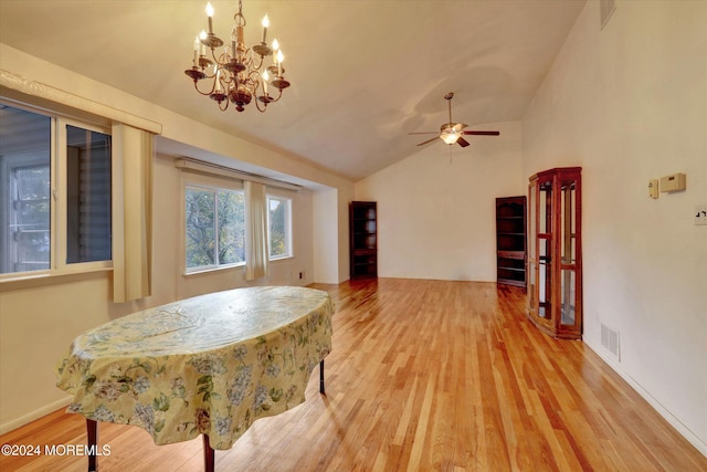 interior space featuring lofted ceiling, hardwood / wood-style floors, and ceiling fan with notable chandelier