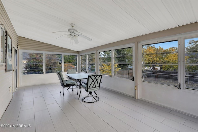 unfurnished sunroom with lofted ceiling and ceiling fan