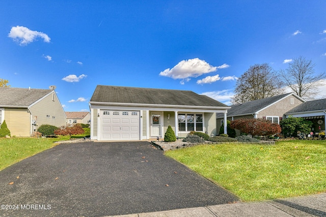 view of front of home with a front yard and a garage