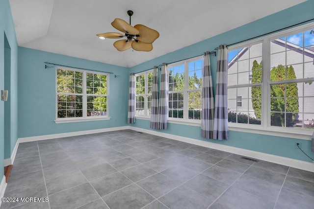 unfurnished sunroom featuring visible vents, vaulted ceiling, and a ceiling fan