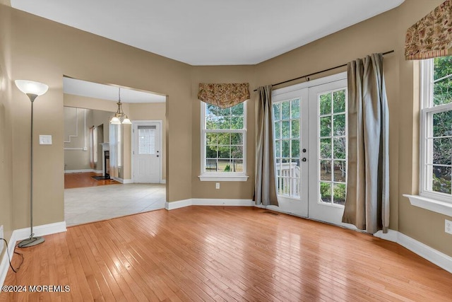 spare room featuring light wood-style flooring, visible vents, baseboards, and french doors