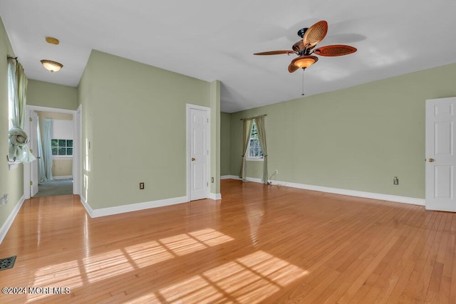 interior space featuring light wood-style floors, ceiling fan, and baseboards