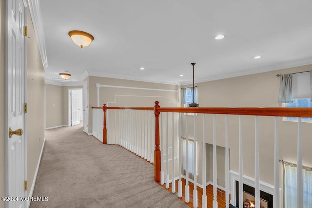 corridor featuring recessed lighting, carpet flooring, baseboards, plenty of natural light, and crown molding