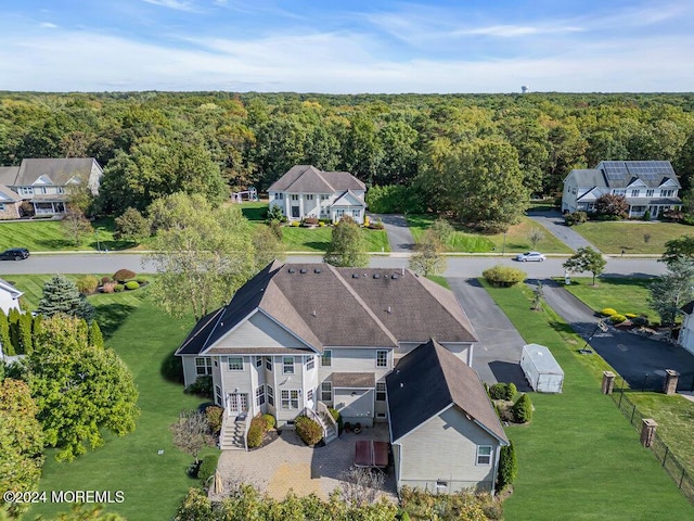 birds eye view of property with a view of trees