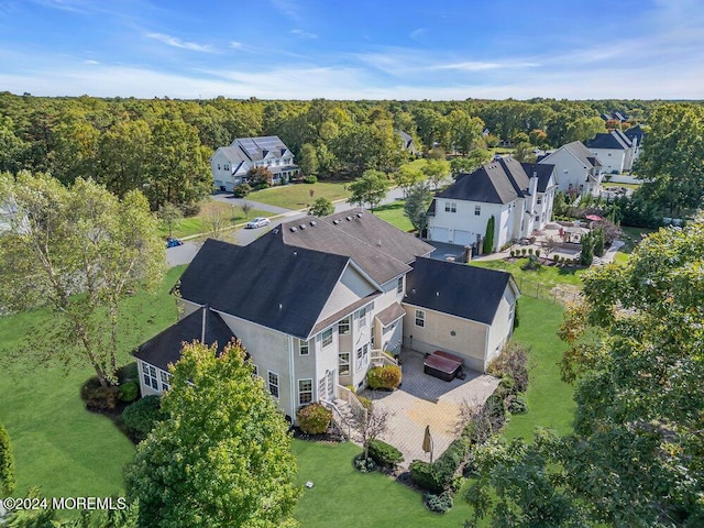 drone / aerial view with a wooded view