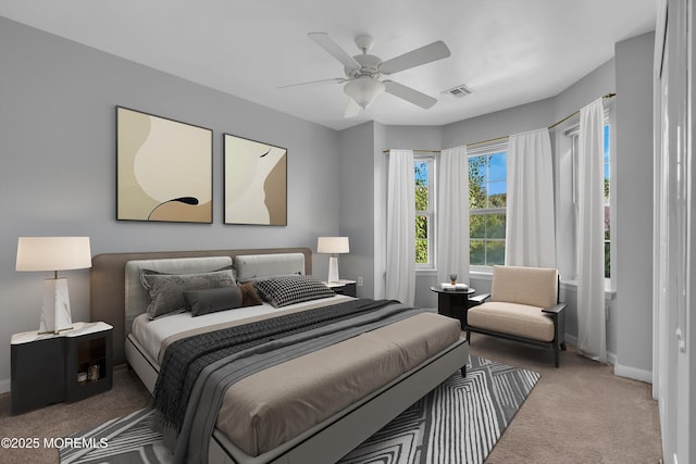 carpeted bedroom featuring a ceiling fan, visible vents, and baseboards