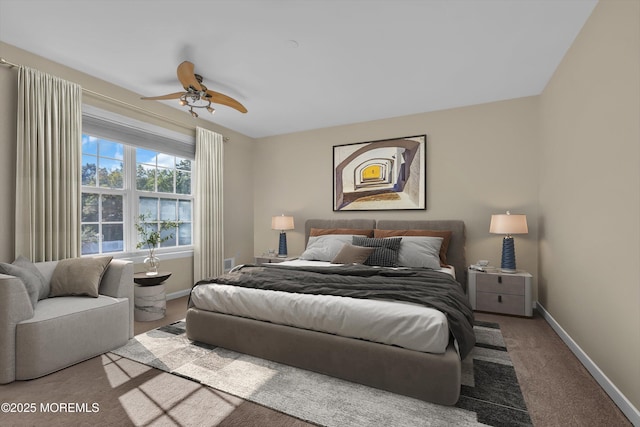 carpeted bedroom with baseboards and a ceiling fan