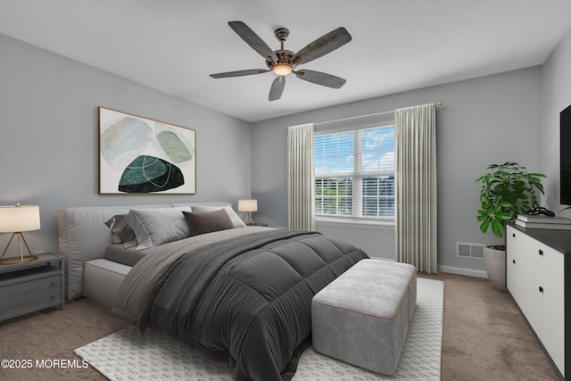 bedroom with ceiling fan, visible vents, baseboards, and light colored carpet