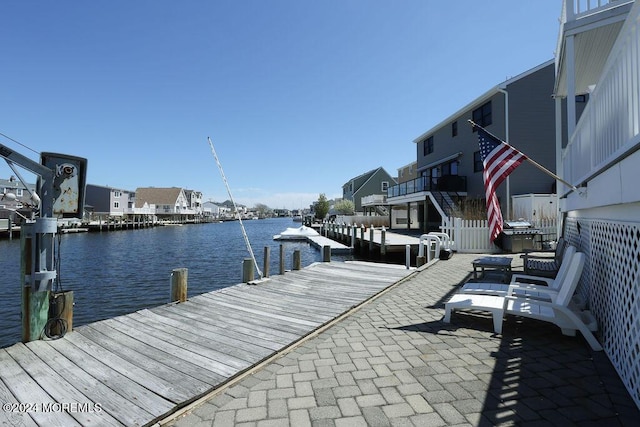 dock area featuring a water view and a residential view