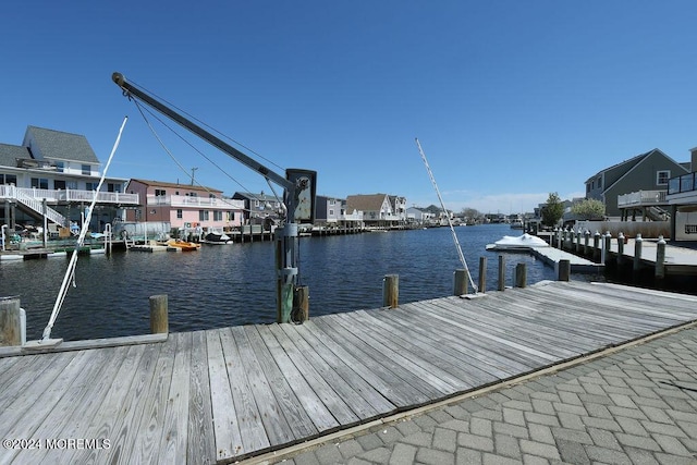 dock area featuring a water view and a residential view