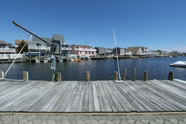dock area with a water view and a residential view