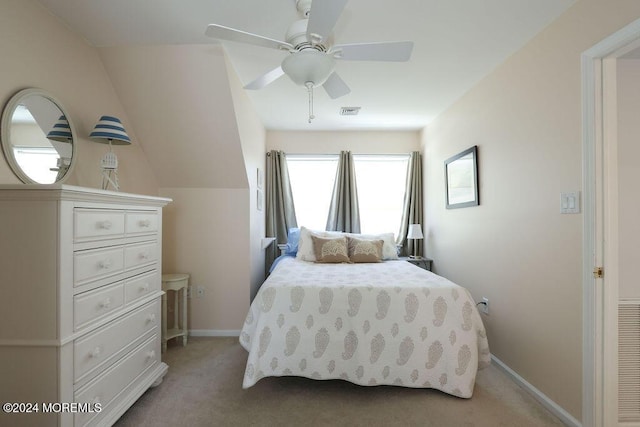 bedroom featuring a ceiling fan, baseboards, light colored carpet, and visible vents