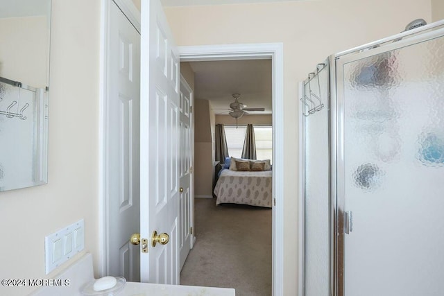 ensuite bathroom featuring ensuite bathroom, a ceiling fan, and a shower stall
