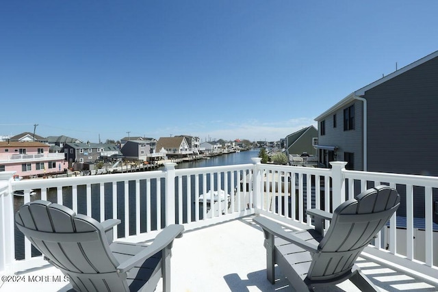 balcony with a water view and a residential view
