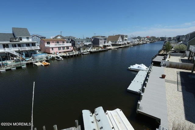 property view of water featuring a residential view and a floating dock