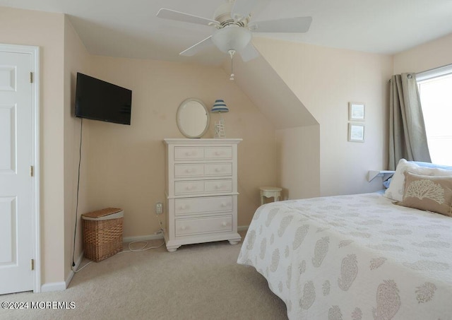bedroom with baseboards, ceiling fan, lofted ceiling, and light colored carpet