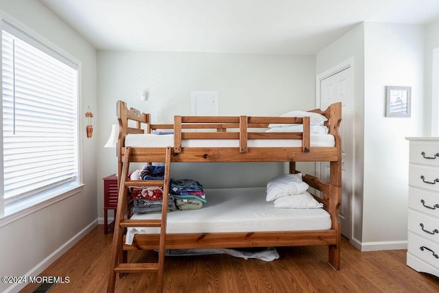 bedroom featuring baseboards and wood finished floors
