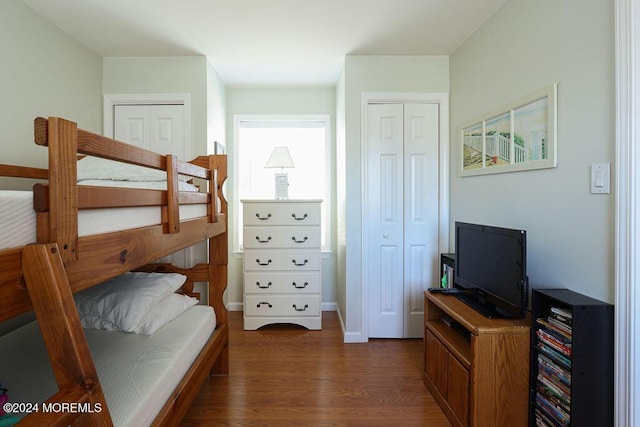 bedroom featuring baseboards and wood finished floors