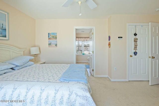 bedroom with carpet floors, a ceiling fan, baseboards, and ensuite bath
