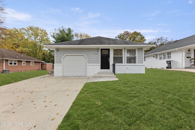 ranch-style house featuring a garage and a front lawn