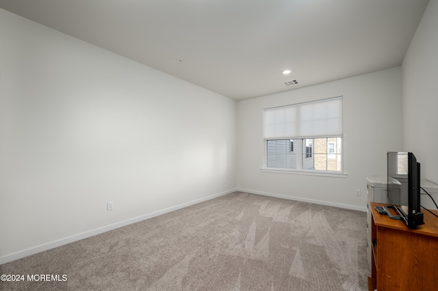 spare room with light colored carpet