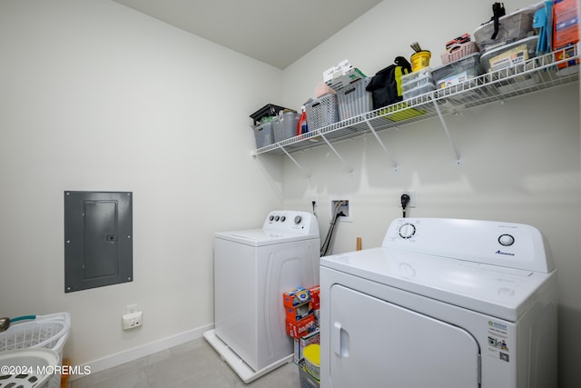 washroom with electric panel, separate washer and dryer, and light tile patterned floors