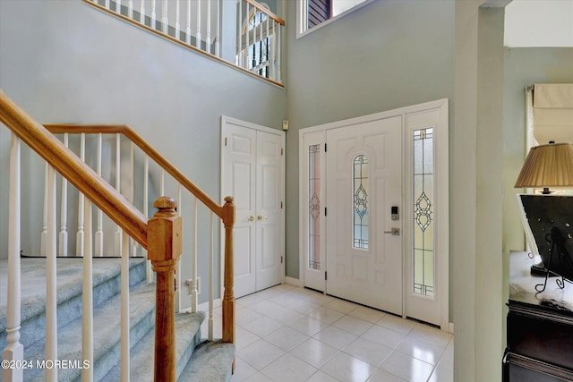 tiled entryway featuring a high ceiling