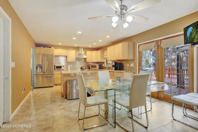 dining room with ceiling fan, light tile patterned flooring, and a textured ceiling