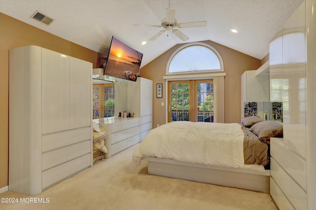 carpeted bedroom featuring access to exterior, french doors, a textured ceiling, vaulted ceiling, and ceiling fan