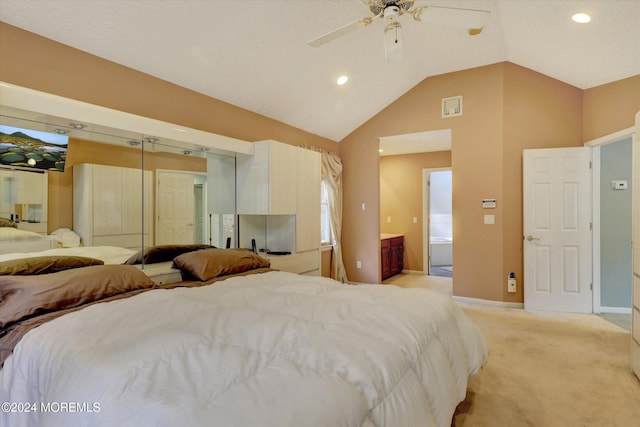 bedroom with connected bathroom, ceiling fan, high vaulted ceiling, light carpet, and a closet