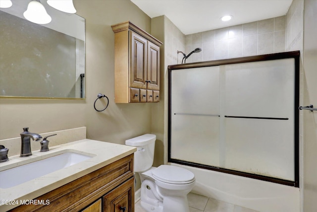 full bathroom with tile patterned floors, combined bath / shower with glass door, toilet, and vanity