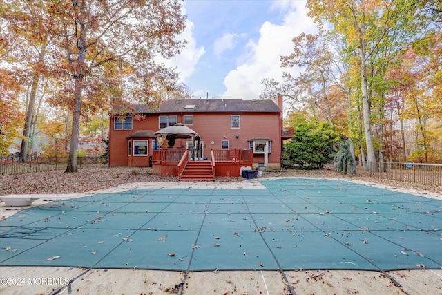 view of swimming pool featuring a deck and a diving board