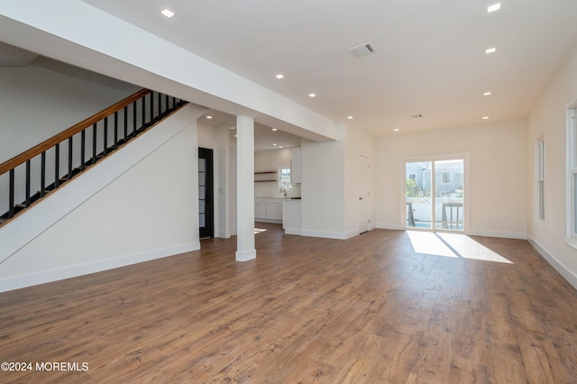 unfurnished living room featuring hardwood / wood-style floors