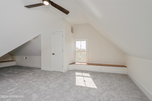 additional living space featuring ceiling fan, light colored carpet, and lofted ceiling