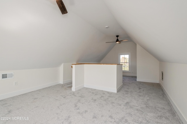 bonus room featuring vaulted ceiling, light colored carpet, and ceiling fan