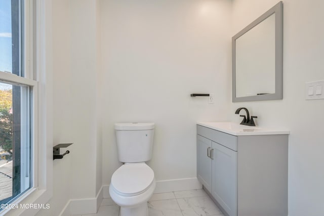 bathroom with toilet and vanity