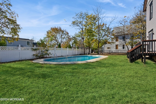 view of swimming pool with a yard