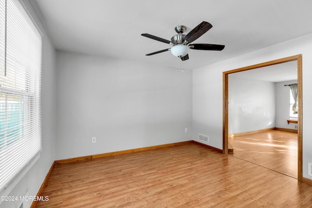 spare room with ceiling fan and light wood-type flooring