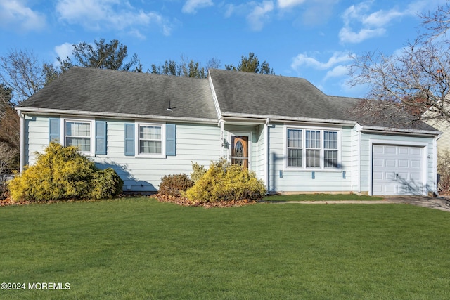 view of front of property featuring a front yard and a garage