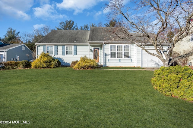 view of front of house featuring a garage and a front lawn