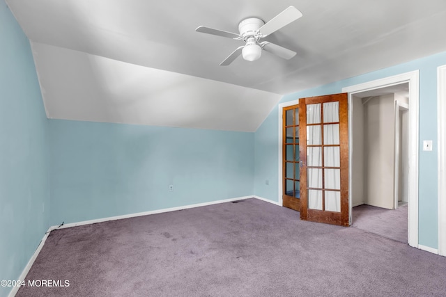 additional living space with ceiling fan, french doors, light colored carpet, and lofted ceiling