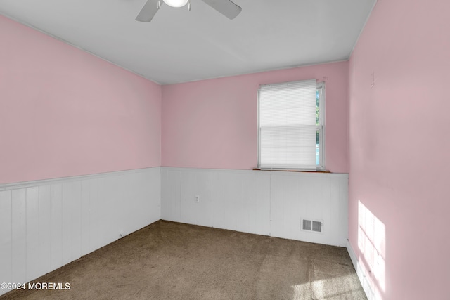 314 Ashford Rd, Toms River, NJ 08755 - empty room with carpet flooring, a wainscoted wall, a ceiling fan, and wood walls